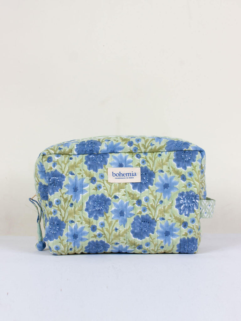 A sage green and blue quilted Floribunda Washbag with floral hand block-printed pattern.