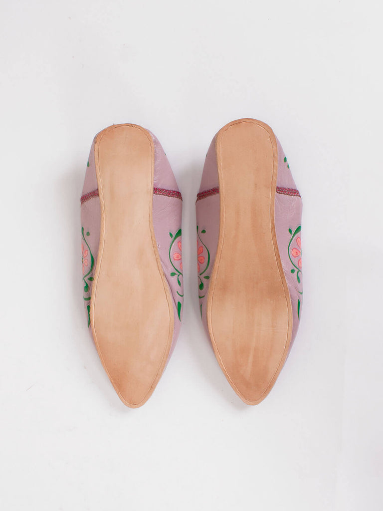 The firm leather soles of a pair of pointed babouche slippers in dusky lilac