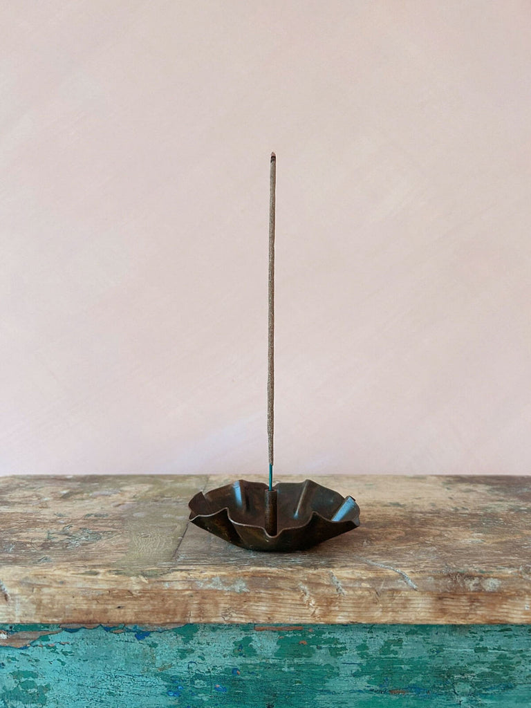 Lotus incense holder on a rustic wood table