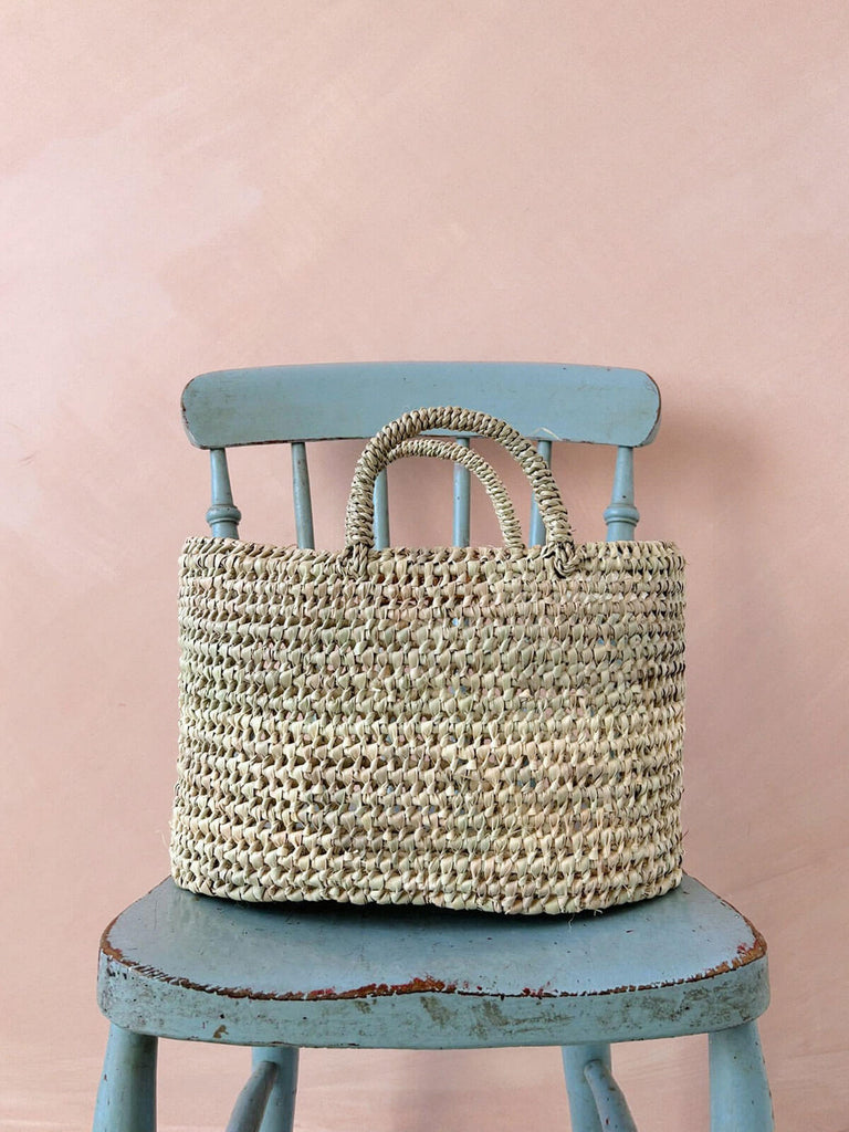 Large wholesale woven basket with short handles and open weave design for shopping or storage