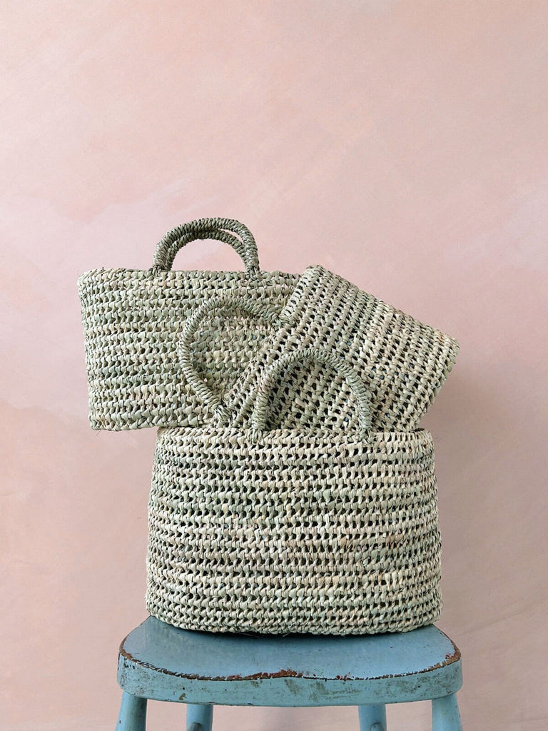 Set of three wholesale woven nesting baskets with oval shape and handcrafted open weave design