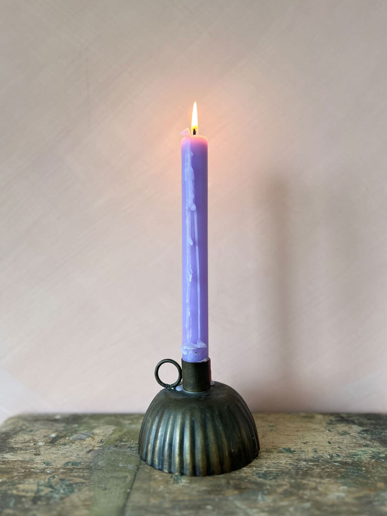 Petticoat candle holder with lilac lit candle