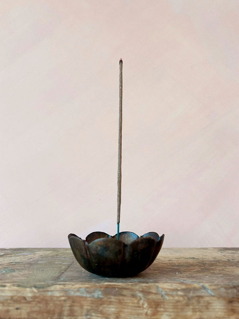 Poppy incense holder on a rustic wood table