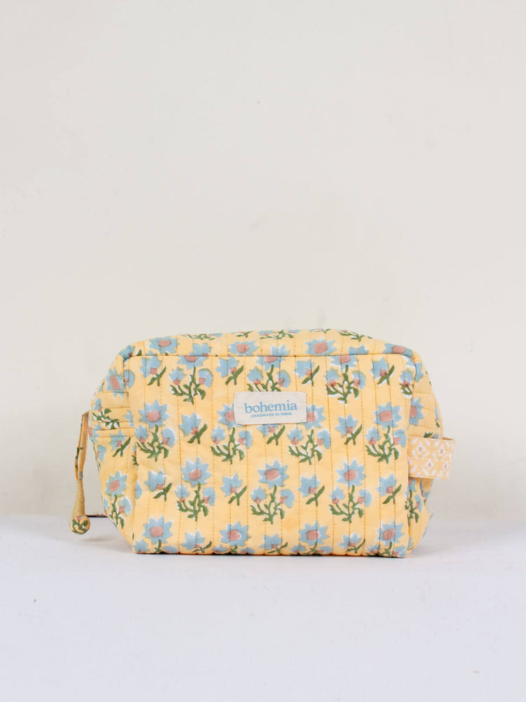 A soft buttermilk yellow and blue hand block printed quilted Posie wash bag