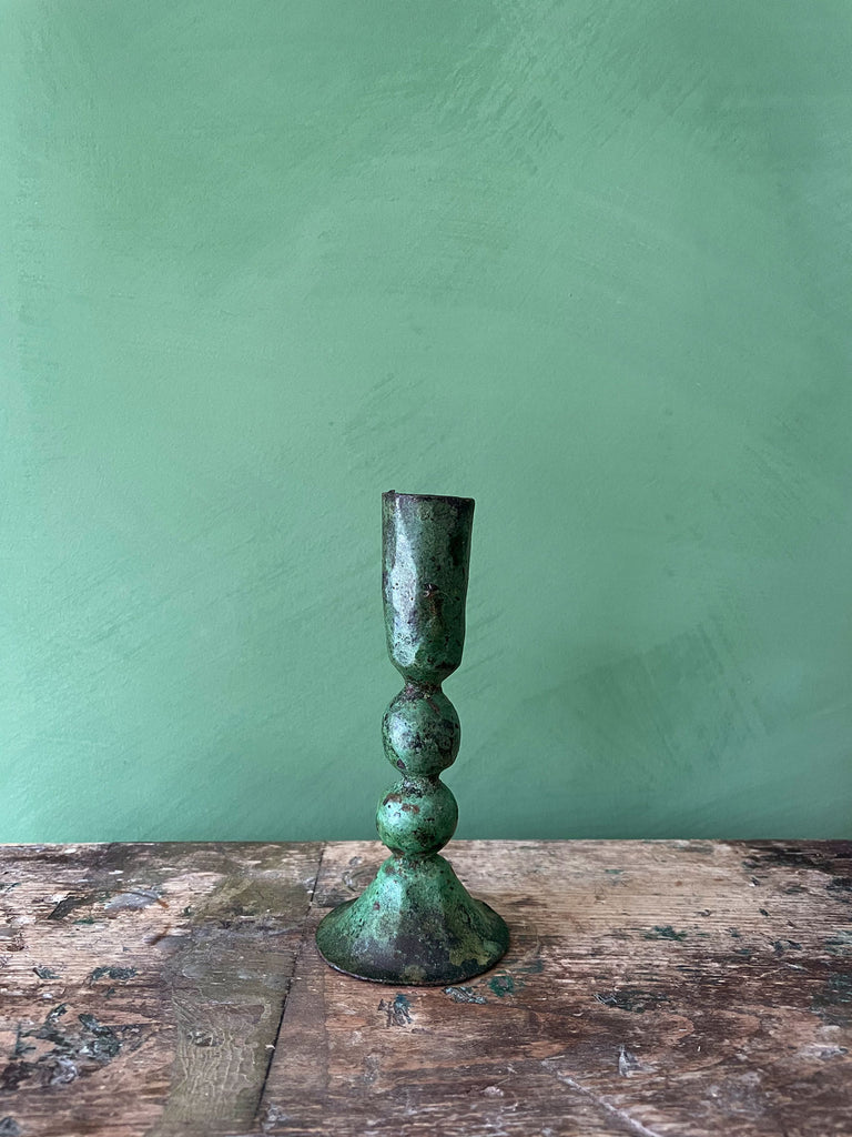 Large Austen iron candle holder in verdigris patina finish on a green background by Bohemia Design