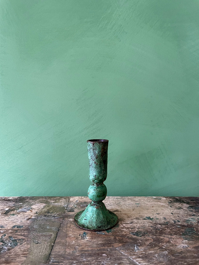 Medium Austen iron candle holder with verdigris patina finish on a green background by Bohemia Design