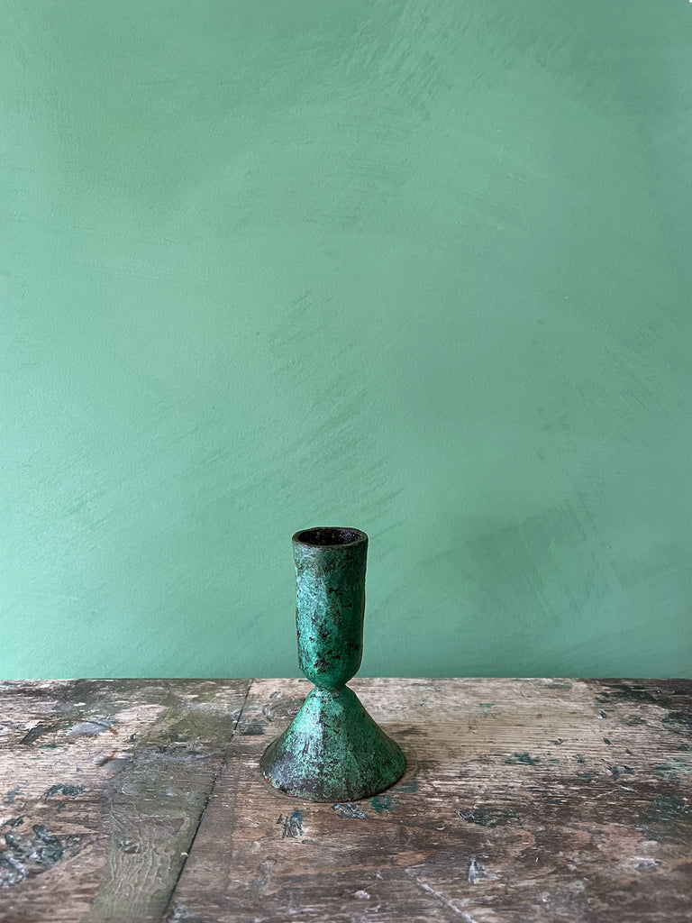 Small Austen iron candle holder with verdigris patina finish on a green background by Bohemia Design