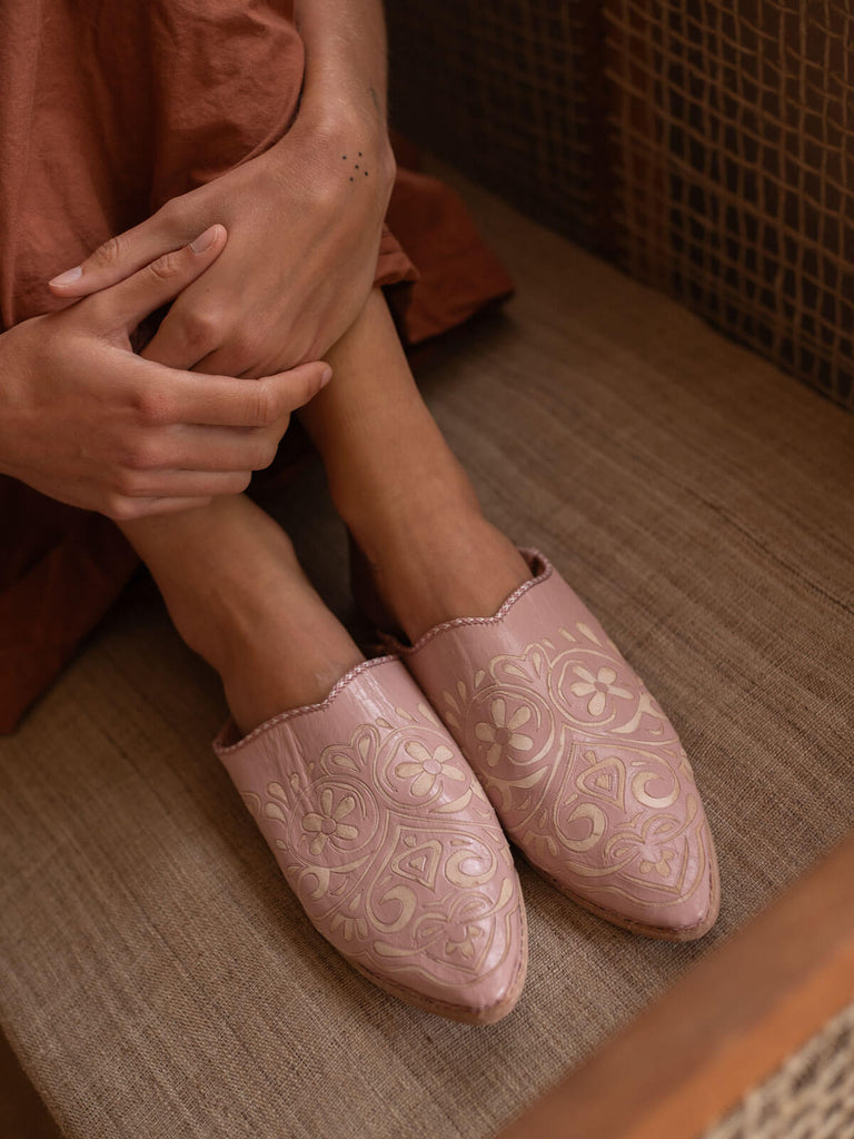 Someone wearing decorative pink leather babouche slippers