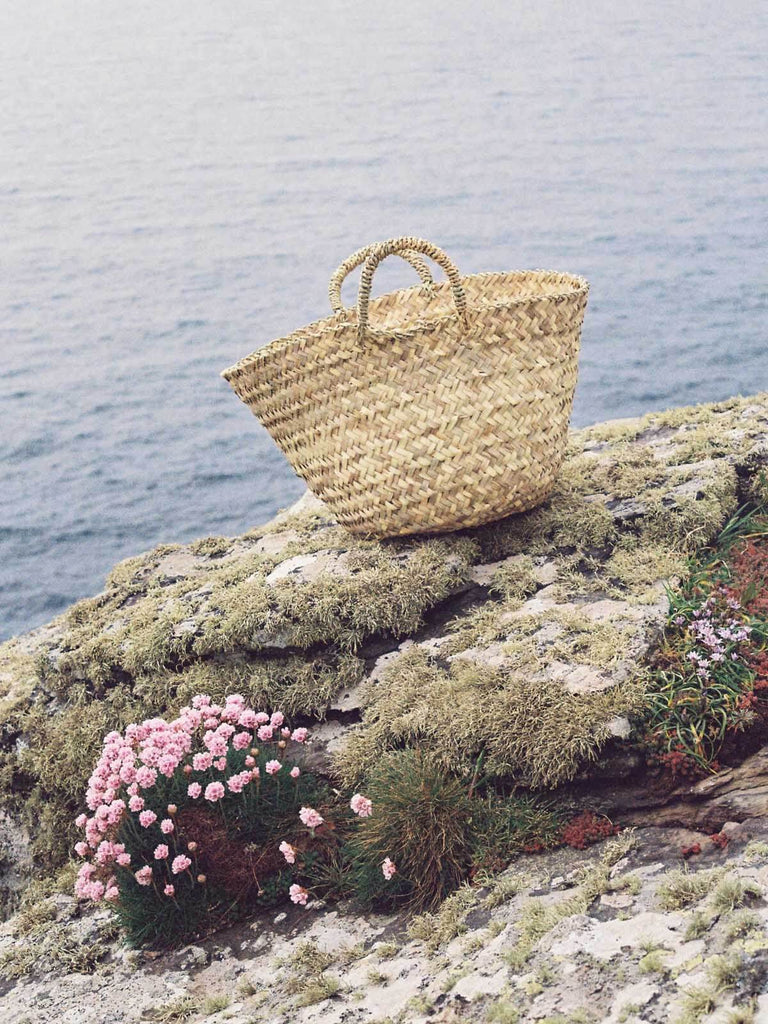 Beldi Basket on flower filled rocks by the sea