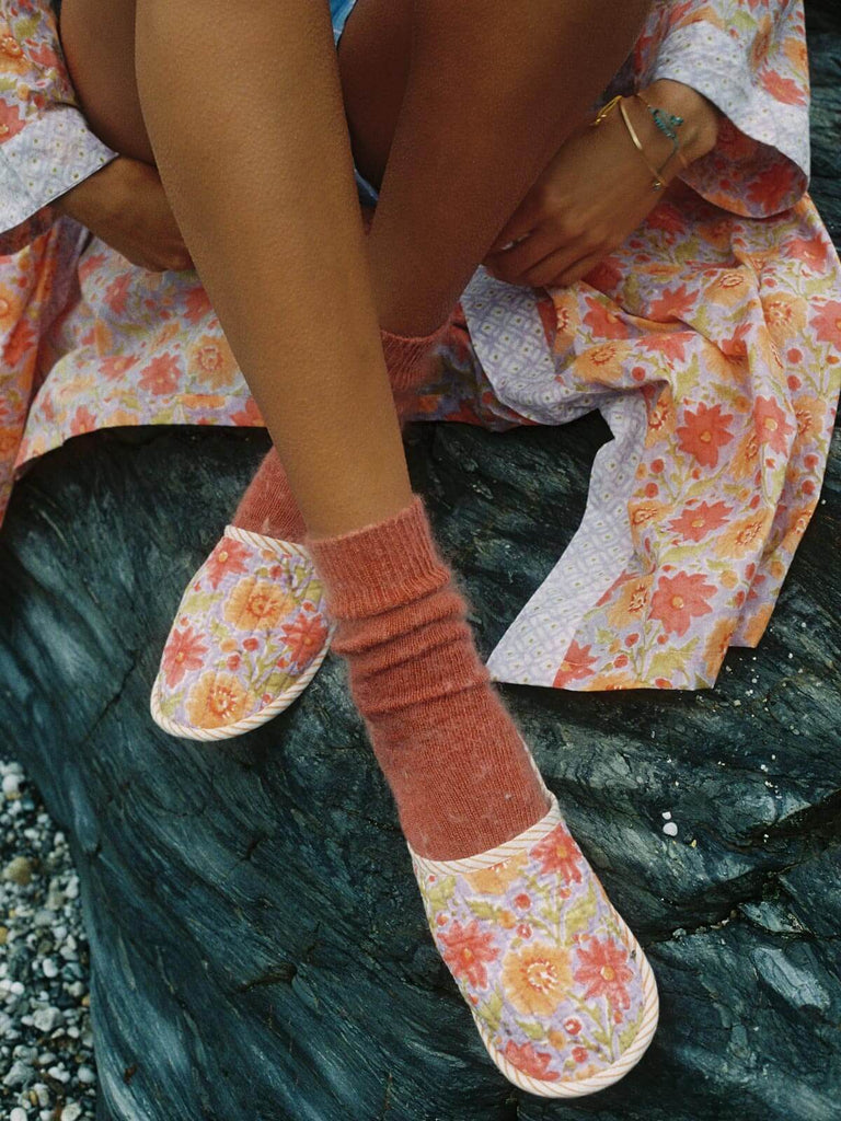 Model wearing lilac quilted floral house slippers with cosy socks