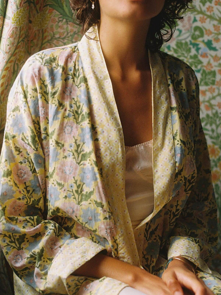 Model wearing a buttermilk block print cotton robe in a country house