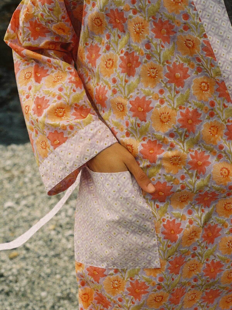 Close up of the pocket of a lilac block print robe.