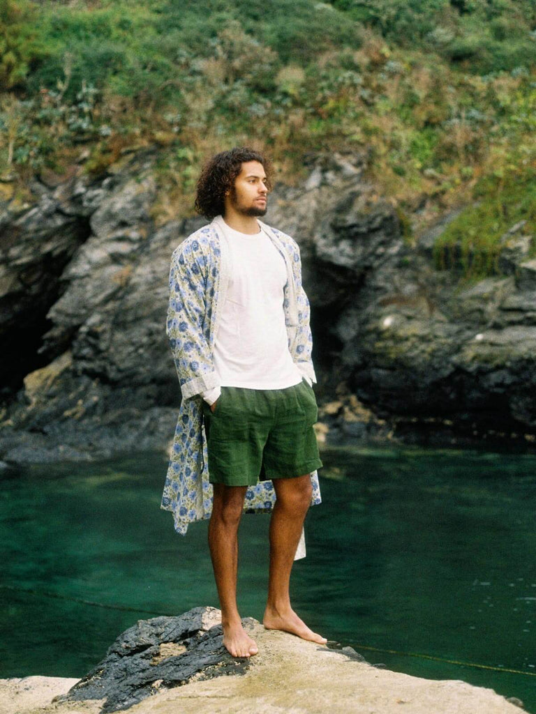 Male model by the sea wearing a Bohemia sage floral block print robe.