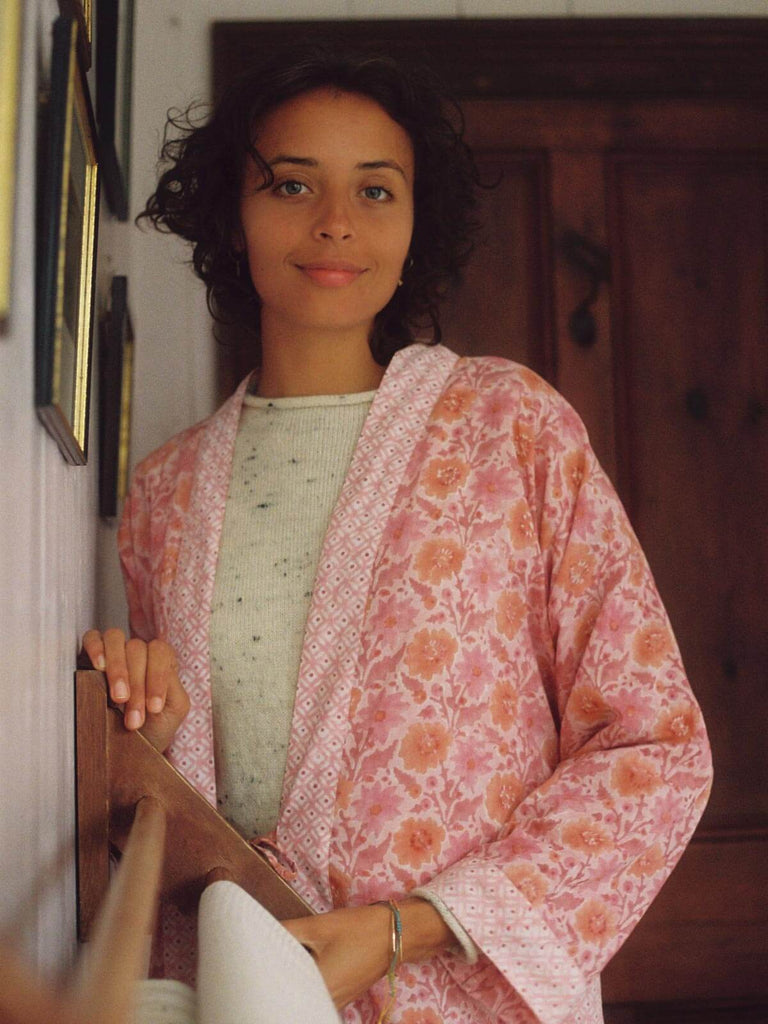 Model in a cottage bathroom wearing Bohemia block print robe in vintage pink