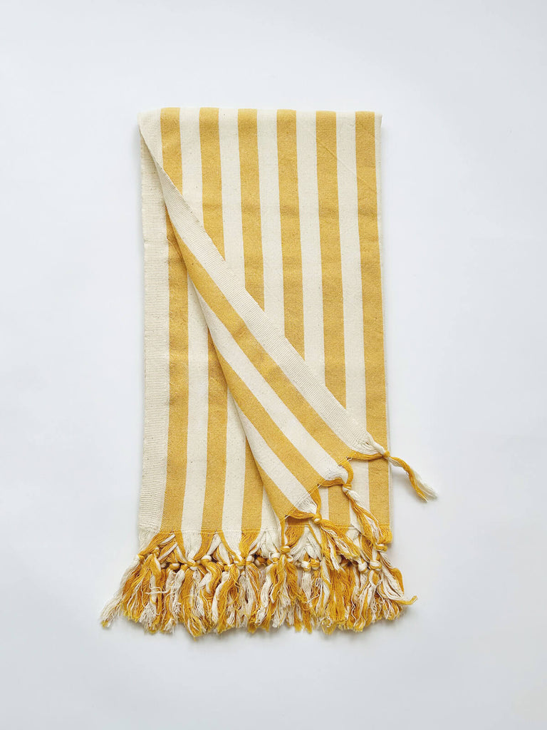 Brighton Stripe hammam towel with a classic mustard yellow seaside stripe and fringe available for wholesale 