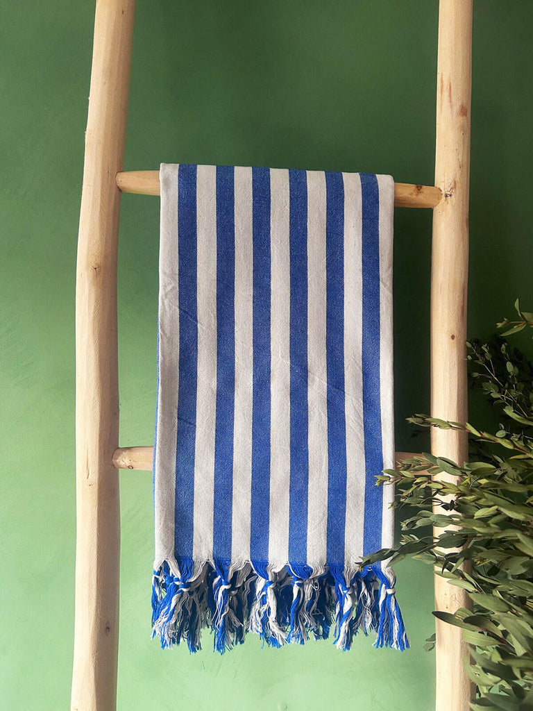 Brighton Stripe hammam towel in blue and white wide stripes on a wooden ladder | Bohemia Design