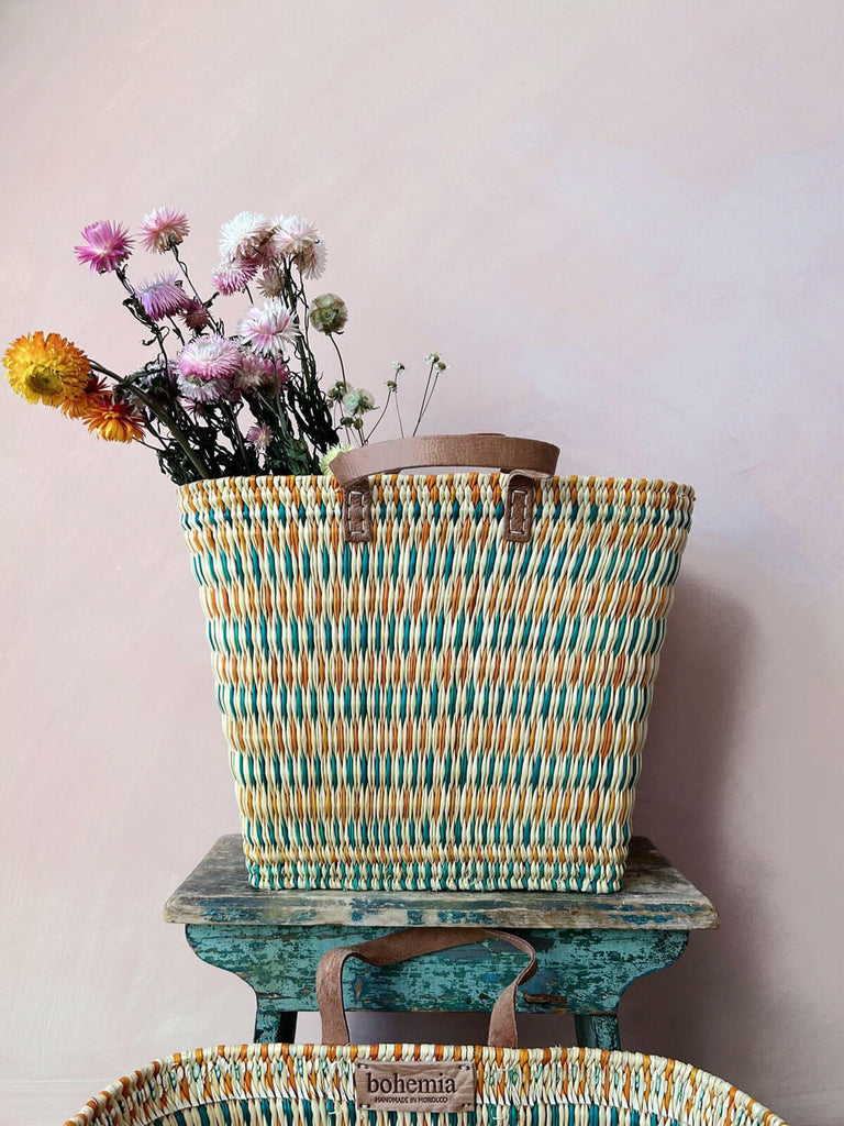 Colourful orange and teal woven wicker reed shopper basket bag with dried flowers for wholesale