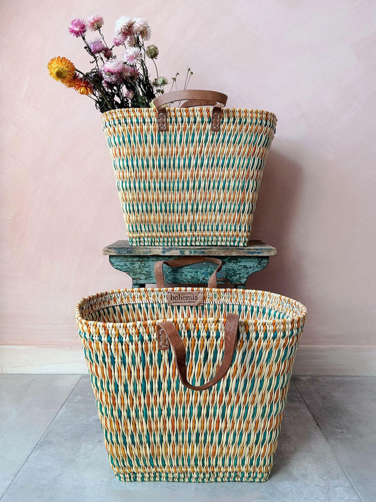 Two tall woven colourful wicker reed shopper baskets bags with leather handles for wholesale 