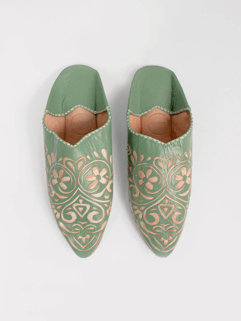 Moroccan decorative babouche slippers in sage green leather with intricate arabesque heart pattern