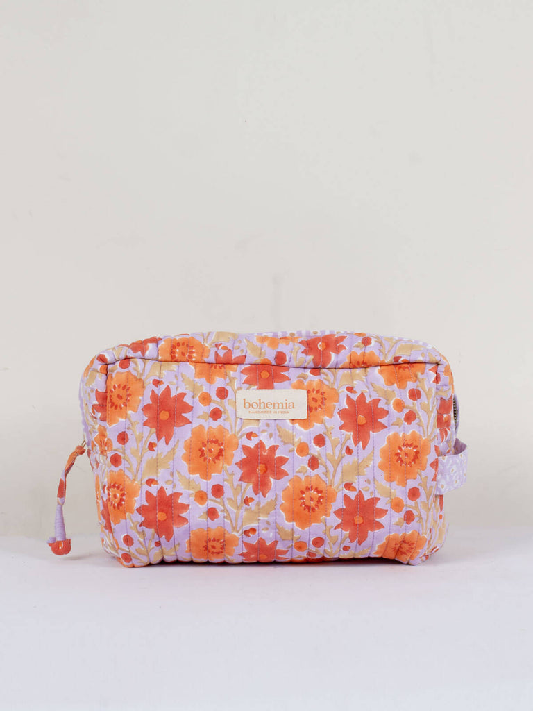 A lilac and orange quilted Floribunda Washbag with floral hand block-printed pattern.