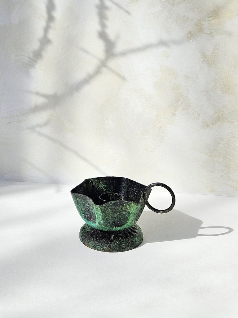 Rustic candle holder in vintage green moss finish, set against a soft, textured background with subtle shadows | Bohemia