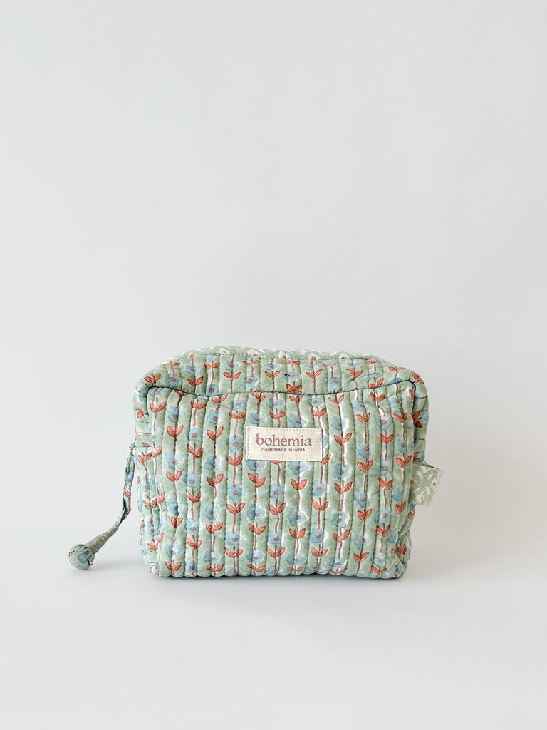 Quilted cotton block print wash bag by Bohemia Design, featuring a charming pale blue and terracotta garland floral pattern on a soft duck egg green base