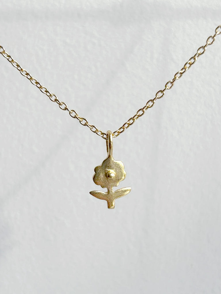 Tiny daisy gold necklace on a fine gold chain by Bohemia Design Wholesale
