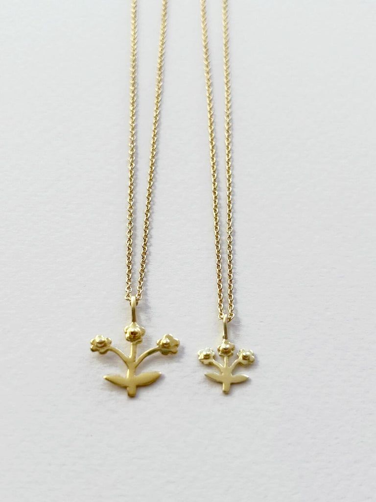Small and tiny wholesale gold plated necklaces with flower pendants on fine gold chains