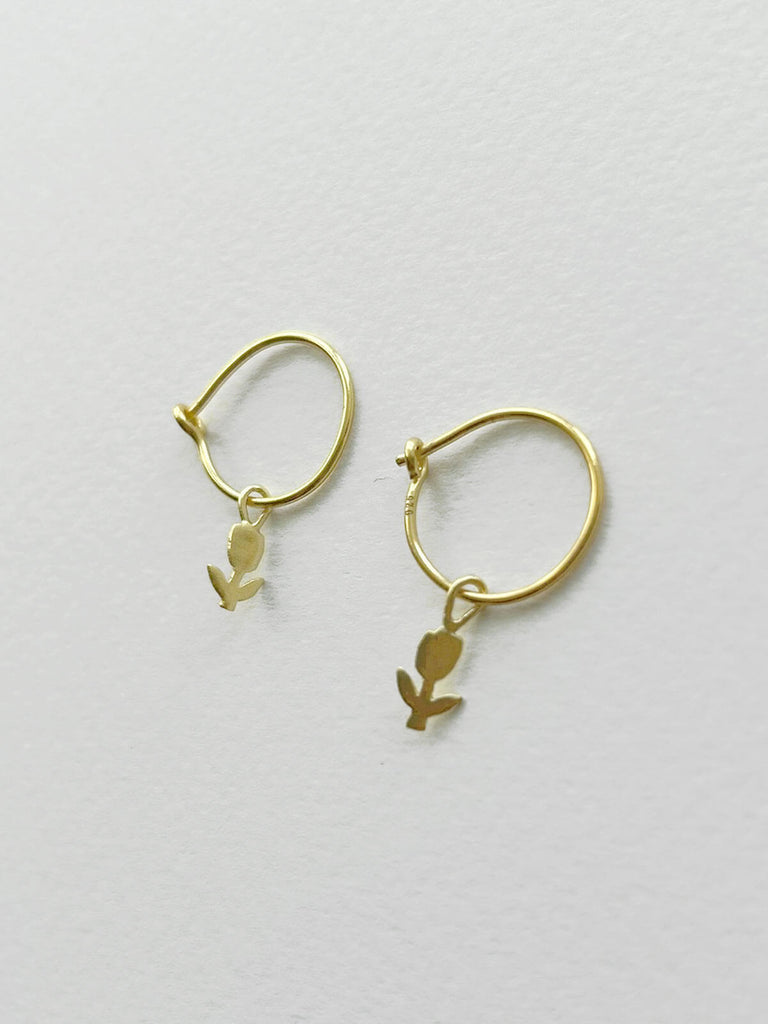 Delicate gold hoop earrings for wholesale with a pretty tulip design