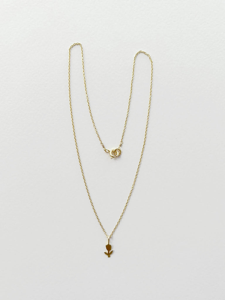 Minimalist gold tulip necklace on delicate gold chain with a tiny flower charm pendant