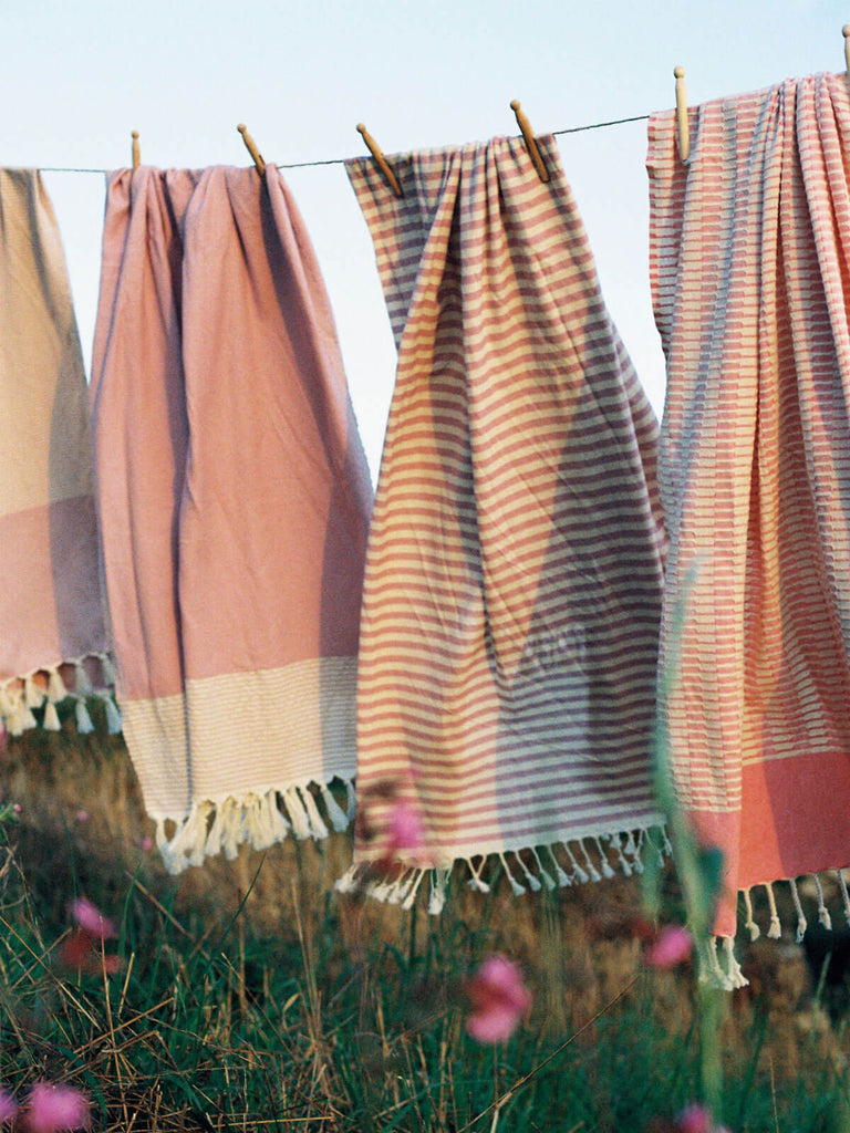 Pink striped cotton hammam towels hanging outside