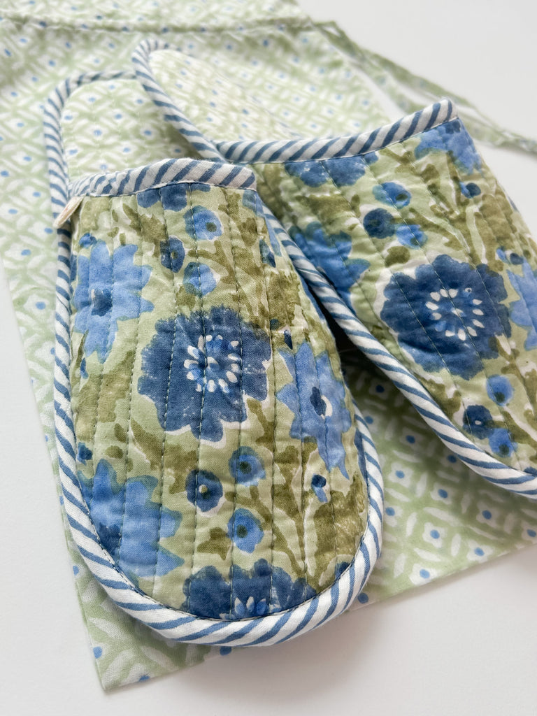 A closeup of beautiful floral house slippers in sage with calming blues and warm mid green accents by Bohemia 