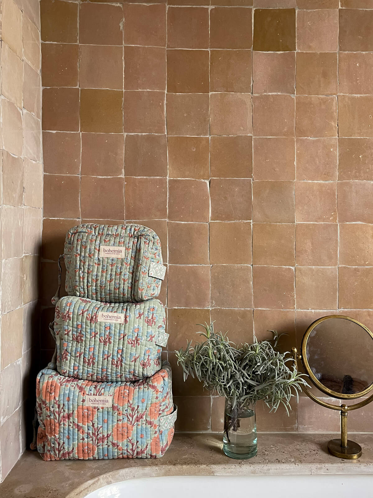 Three hand block printed washbags in soft duck egg, set in a Moroccan bathroom with square, sand-toned tiles | BohemiaDesign 