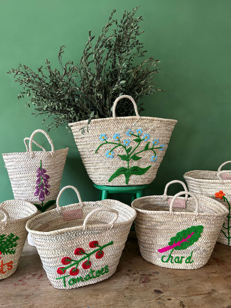Collection of wholesale hand embroidered baskets in various shapes, sizes and designs by Bohemia Design