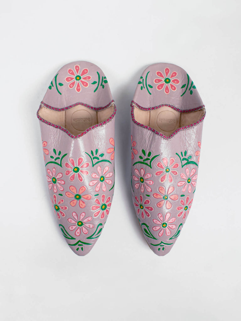 A pair of pointed babouche slippers dusky lilac leather with colourful hand painted floral pattern