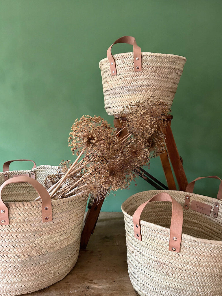 Set of three natural storage baskets with leather handles