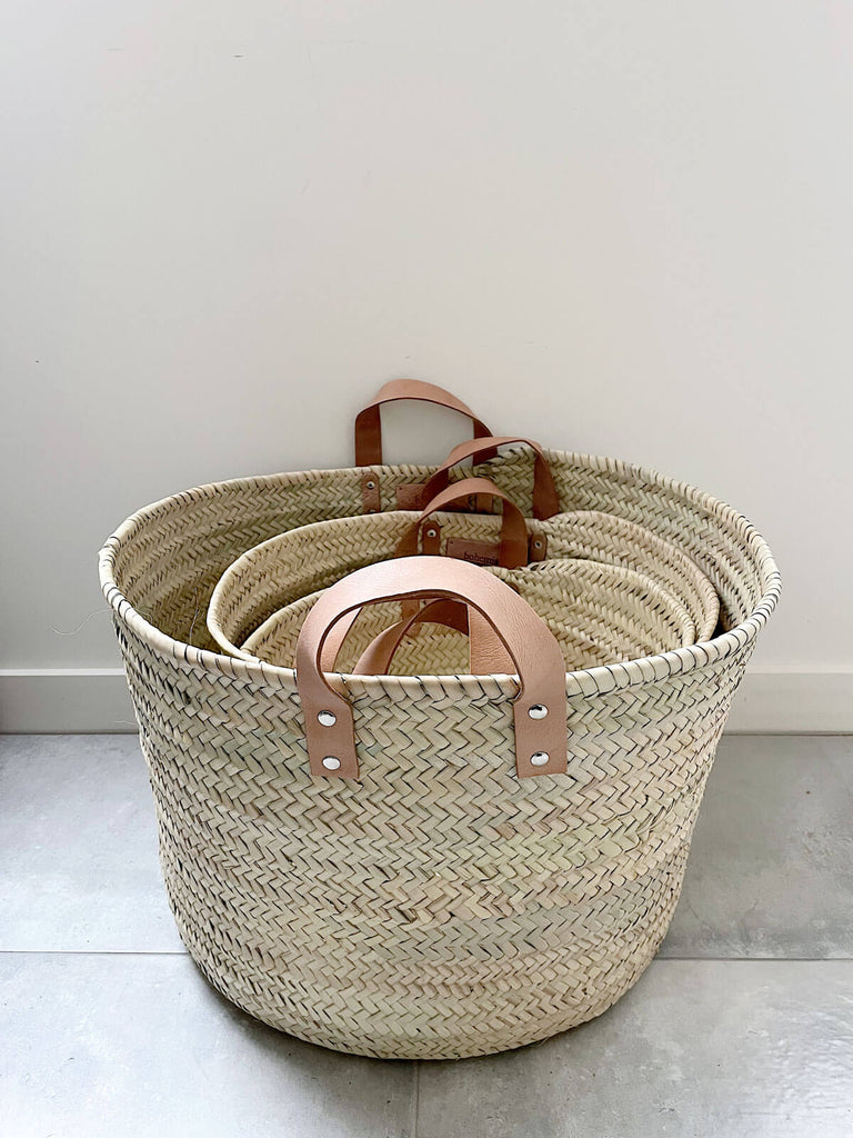 Set of three storage baskets with leather handles