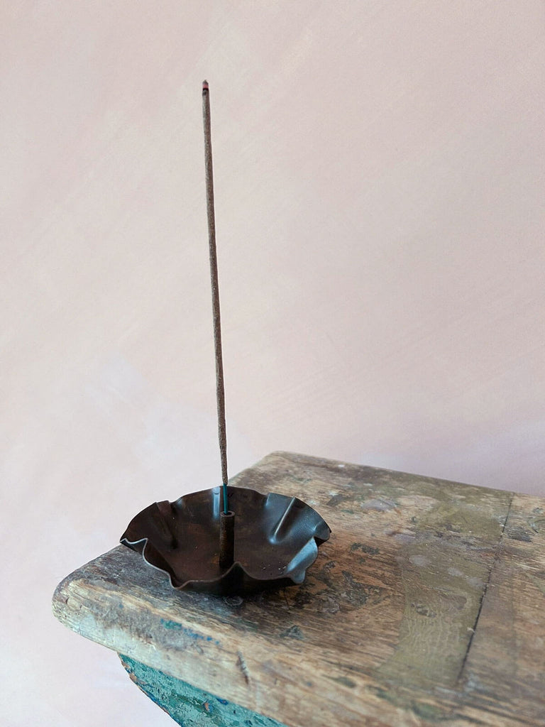 Delicate metal incense holder with lotus flower inspired shape
