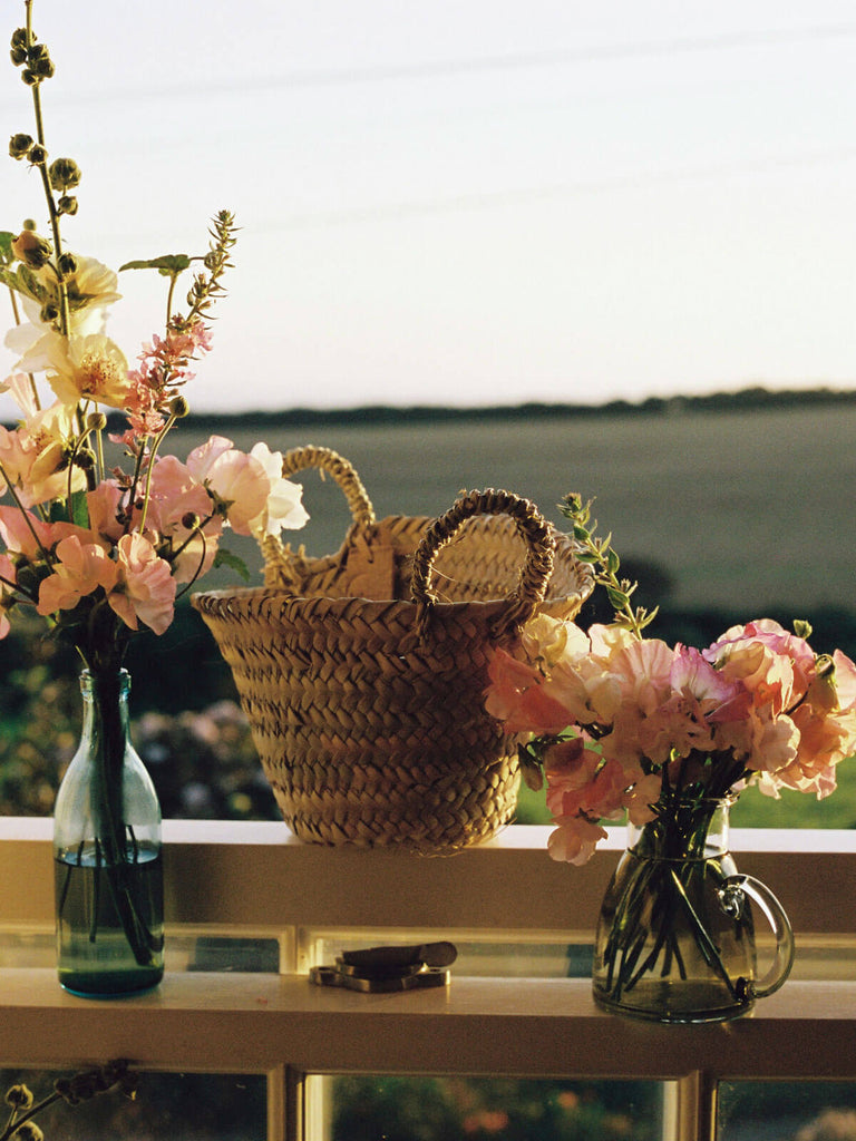 Mini beldi basket on a windowsill with spring flowers