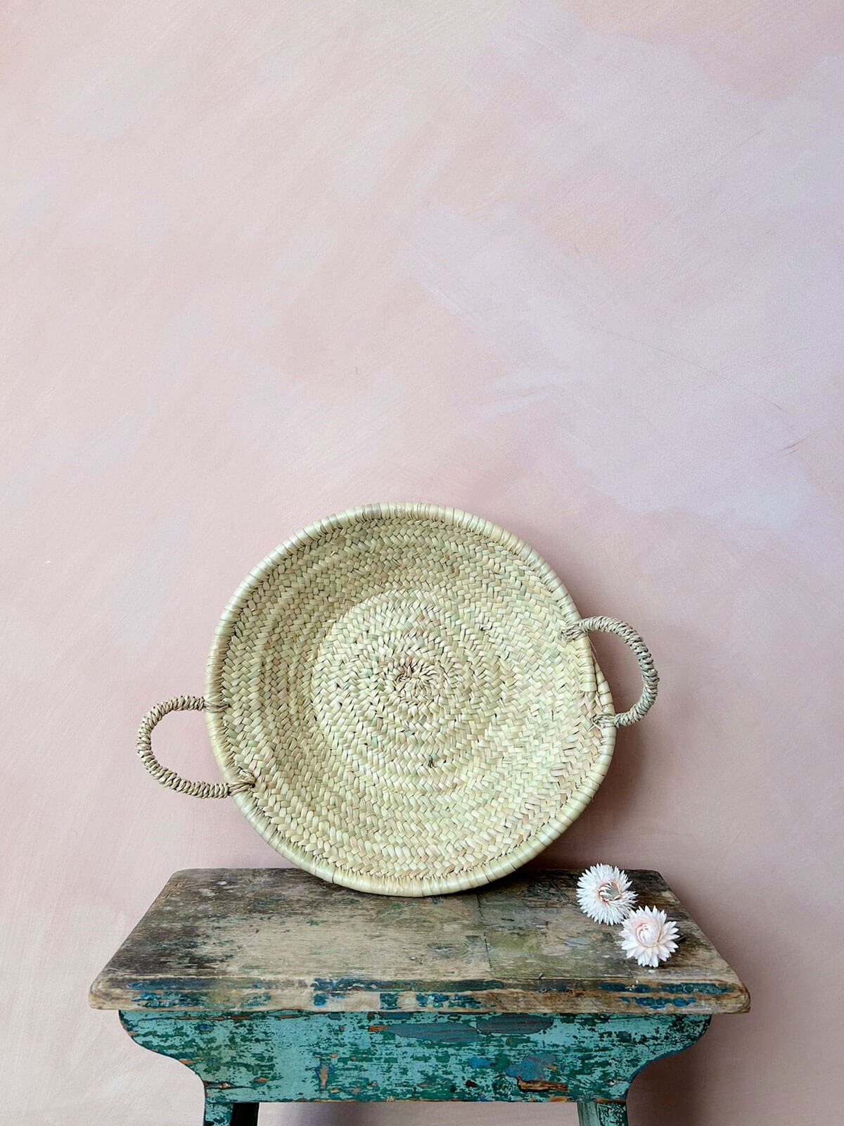 Small Moroccan oversized woven plate on a vintage stool