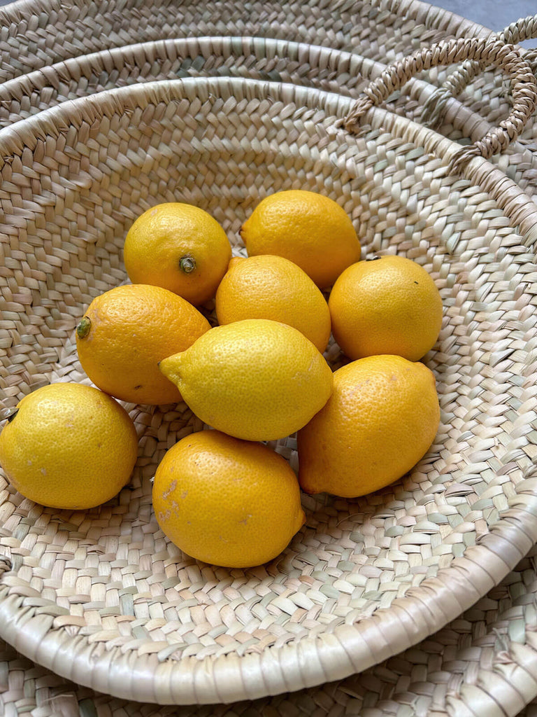 Moroccan woven plate as a fruit platter holding lemons