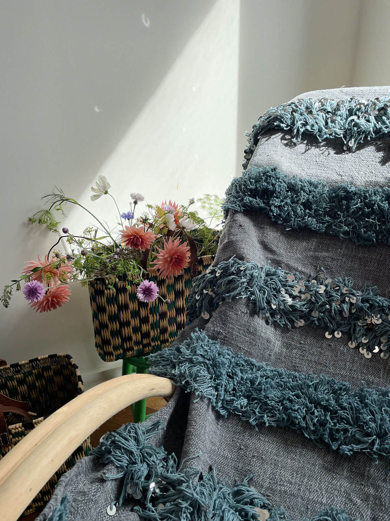 Modern handira blanket dyed a contemporary grey and embellished with soft fringing and silver sequins.