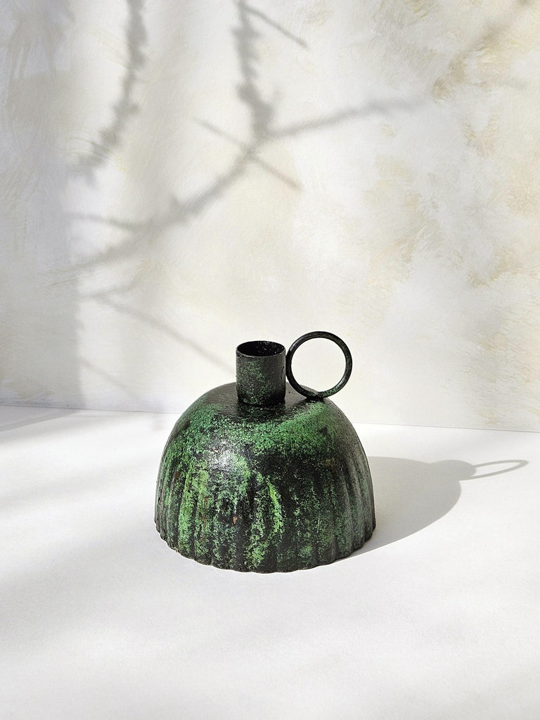 Rustic Petticoat candle holder in vintage green moss finish, set against a soft, textured background with subtle shadows | Bohemia