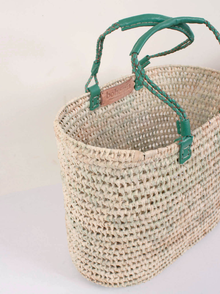 Oval shaped shopping basket with sage green pleated leather handles