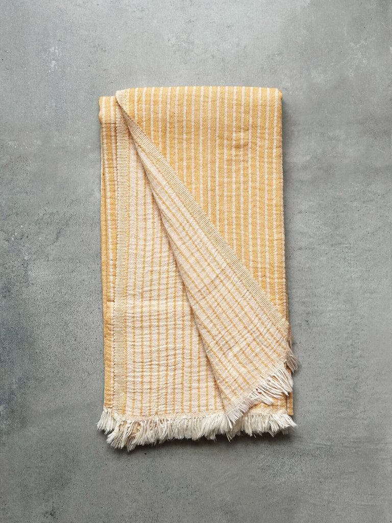 Wholesale Portobello hammam towel in mustard yellow, revealing a soft textured striped pattern on both sides | Bohemia Design