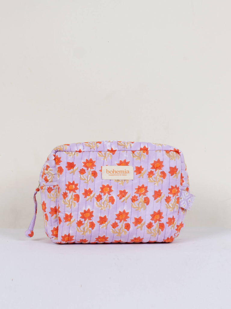 A lilac and orange and blue hand block printed quilted Posie wash bag
