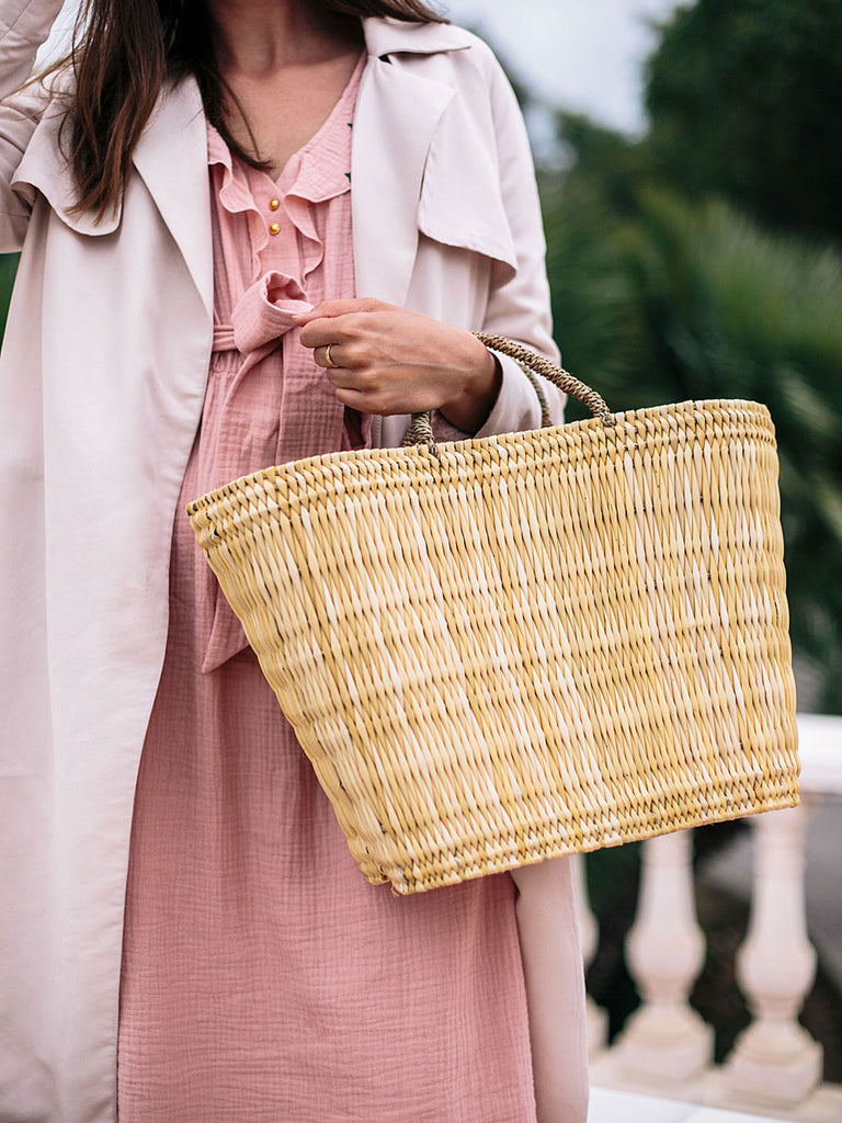 Model holding a Reed Shopper Basket Bag