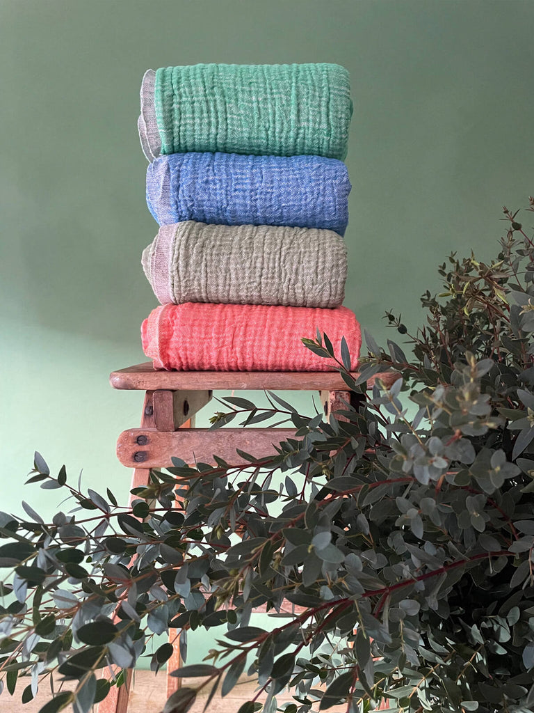 A stack of hammam towels in various colours and textures by BohemiaDesign