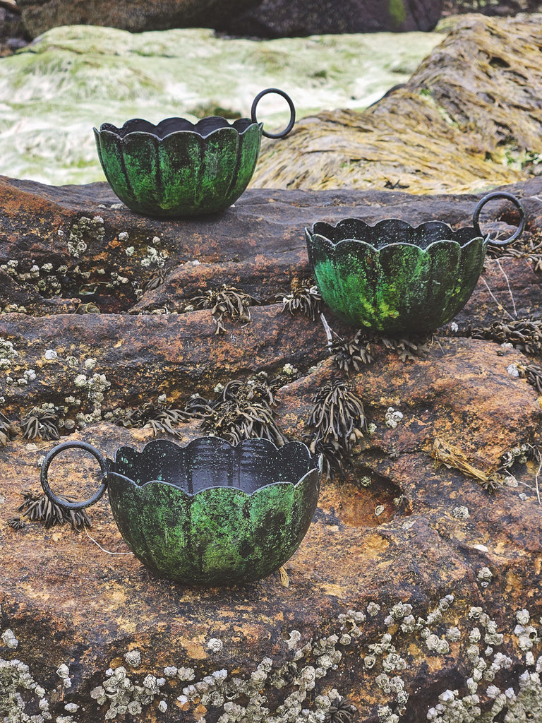 Three scallop candle holders in vintage moss finishes blend seamlessly with textured rocks covered in barnacles and seaweed | Bohemia