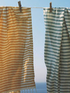 Striped Sorrento Hammam Towels hanging on a washing line by Bohemia Design